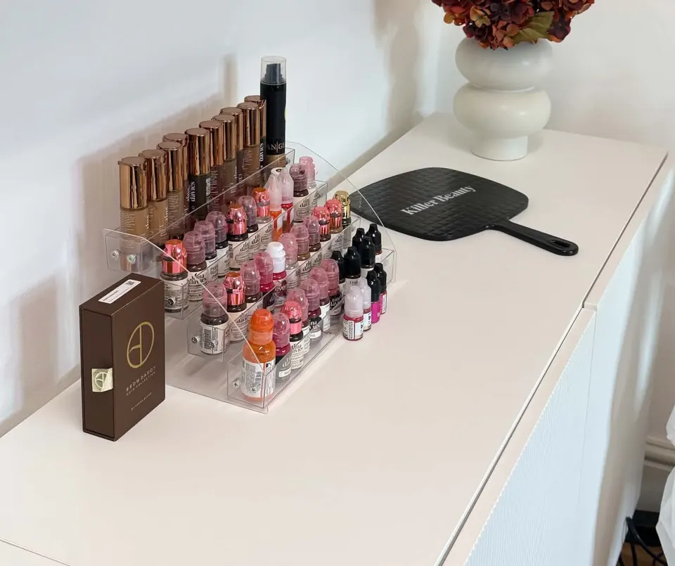 Pigments and a hand mirror on a white sideboard at Defined Studio
